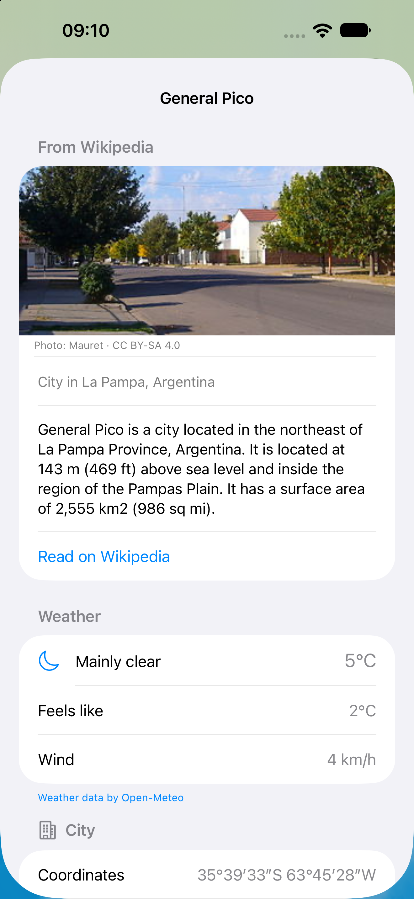 A place card with a photograph, summary and current weather
